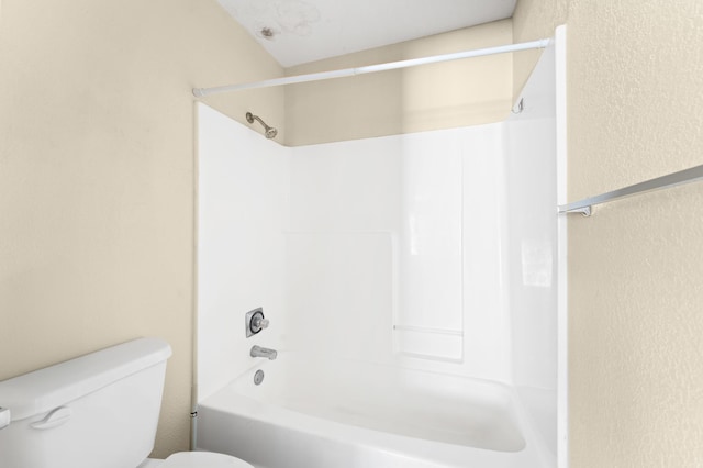 bathroom with shower / bathing tub combination and toilet