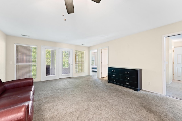 sitting room featuring light carpet and ceiling fan