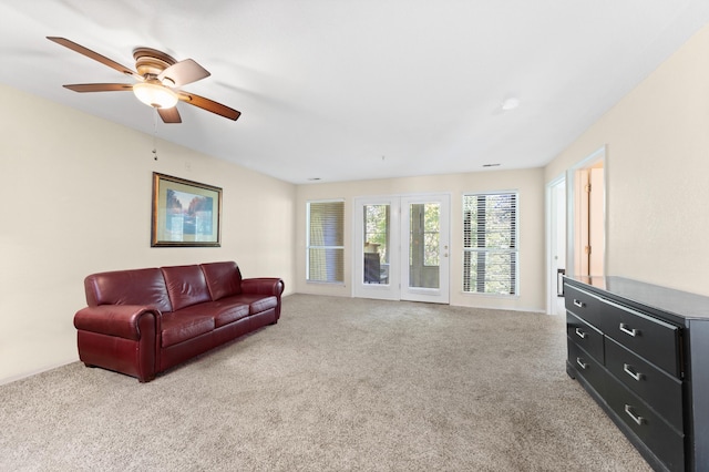 living room with ceiling fan and light colored carpet