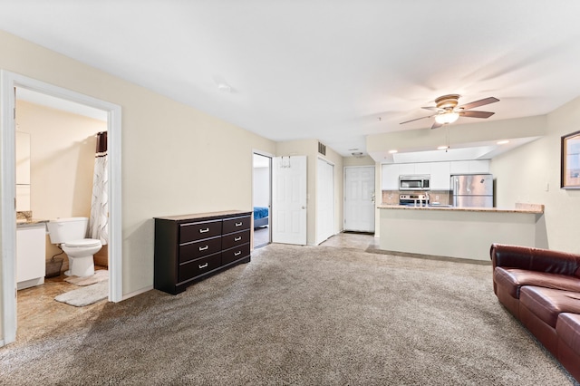 carpeted living room featuring ceiling fan