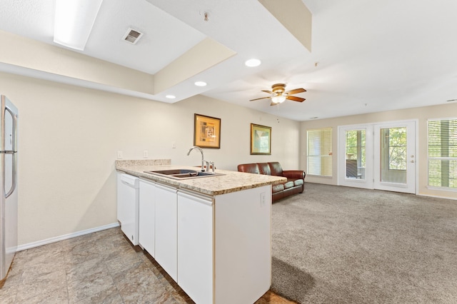 kitchen with sink, kitchen peninsula, white cabinetry, dishwasher, and light carpet