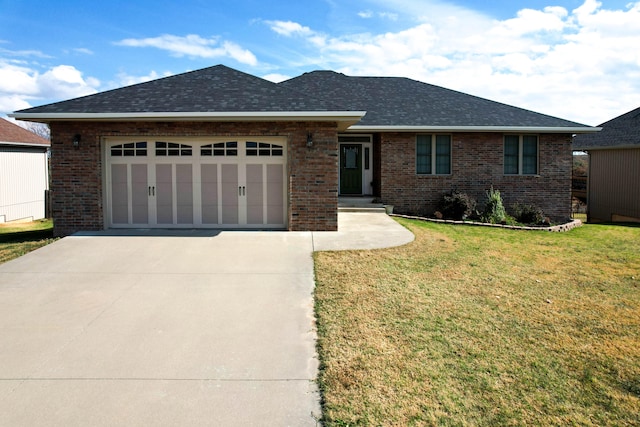 view of front facade featuring a front yard and a garage