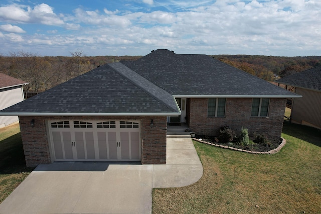 ranch-style house featuring a front yard and a garage