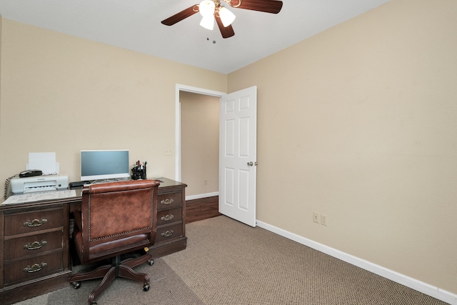 carpeted office featuring ceiling fan