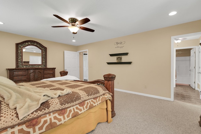 carpeted bedroom featuring ensuite bath and ceiling fan