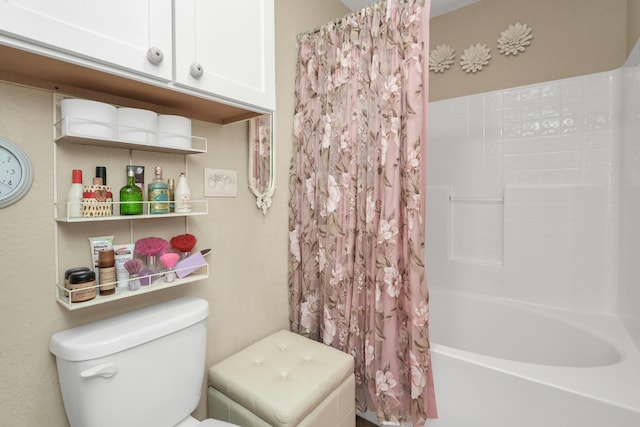 bathroom featuring shower / bath combination with curtain and toilet