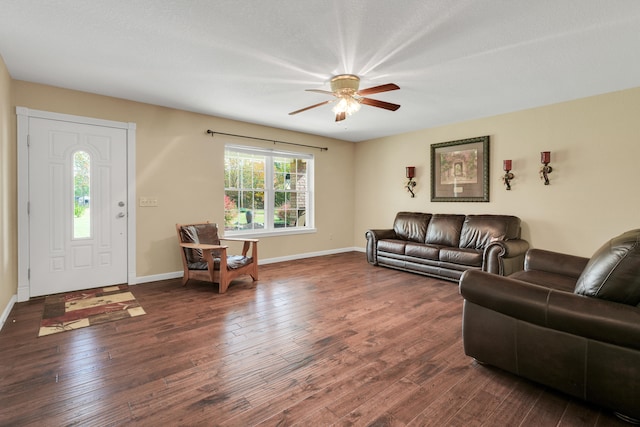 living room with ceiling fan and dark wood-type flooring