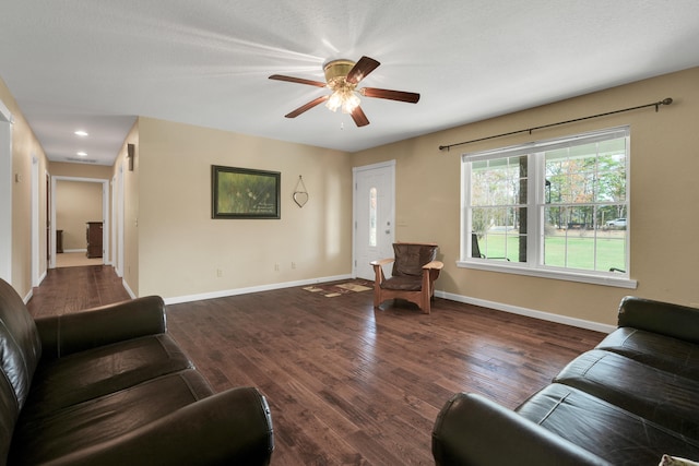 living room with ceiling fan and dark hardwood / wood-style floors