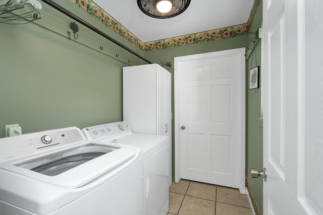 washroom with light tile patterned flooring and washing machine and dryer