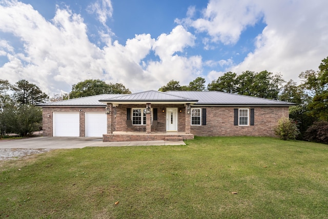 single story home with a porch, a front yard, and a garage