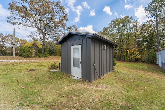 view of outbuilding with a yard