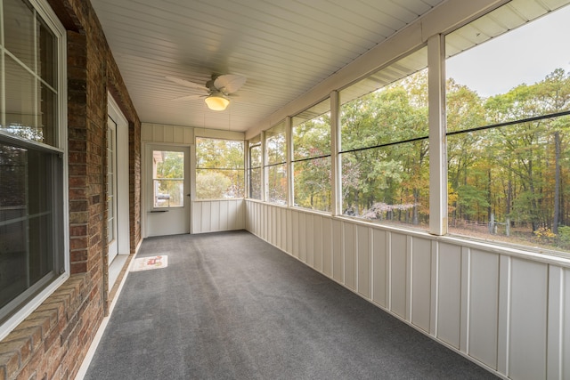 unfurnished sunroom featuring ceiling fan