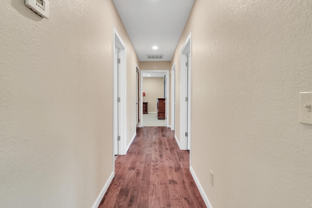 corridor featuring wood-type flooring