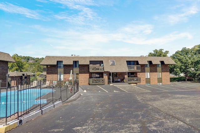 view of building exterior featuring a community pool