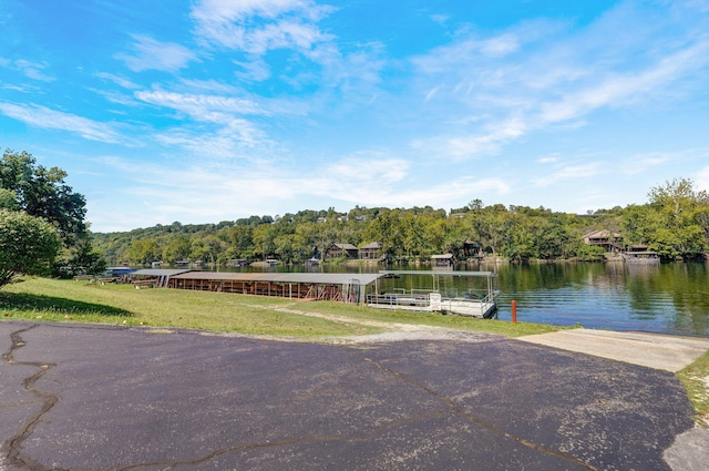 exterior space featuring a water view and a yard