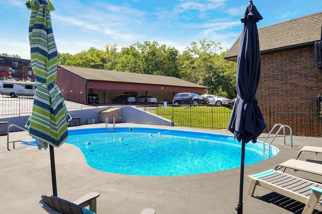 view of swimming pool featuring a patio area