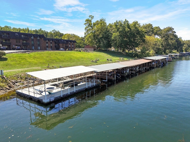 view of dock featuring a water view and a yard