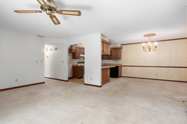 unfurnished living room featuring light colored carpet, ceiling fan with notable chandelier, and sink