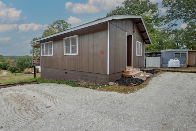 view of side of home with an outbuilding