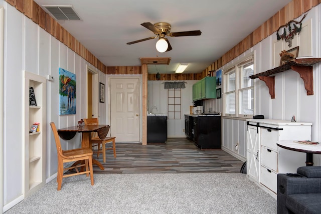 kitchen featuring green cabinetry, ceiling fan, wood-type flooring, white cabinetry, and built in shelves