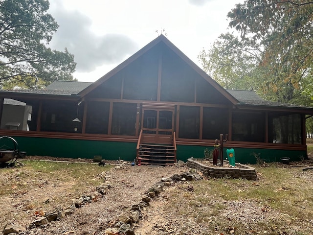 back of house featuring a sunroom