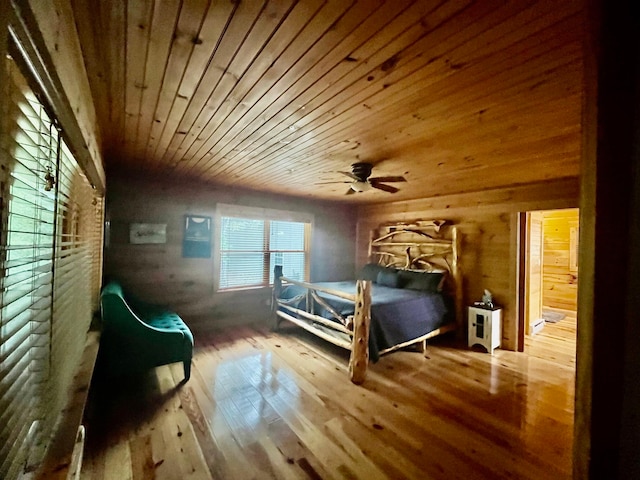 bedroom with ceiling fan, wood ceiling, and hardwood / wood-style floors