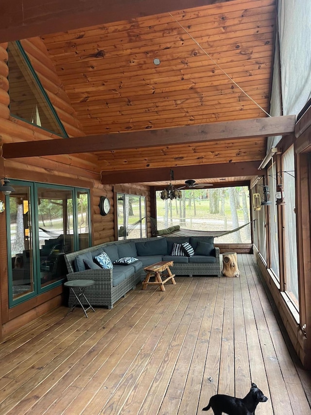 unfurnished sunroom featuring a notable chandelier, wood ceiling, vaulted ceiling, and a healthy amount of sunlight