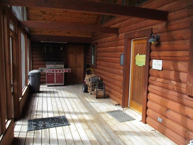 wooden deck featuring a grill