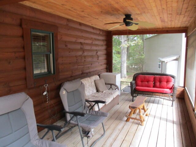 sunroom / solarium with wooden ceiling and ceiling fan