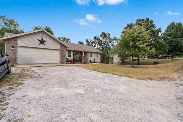 ranch-style house featuring a front lawn and a garage