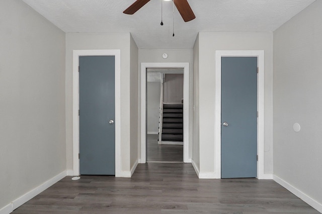 unfurnished bedroom with a closet, dark hardwood / wood-style floors, a textured ceiling, and ceiling fan