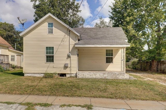 rear view of property with a lawn