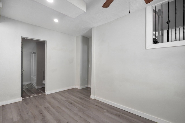 spare room featuring ceiling fan and hardwood / wood-style floors