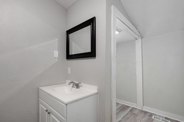 bathroom featuring hardwood / wood-style flooring and vanity