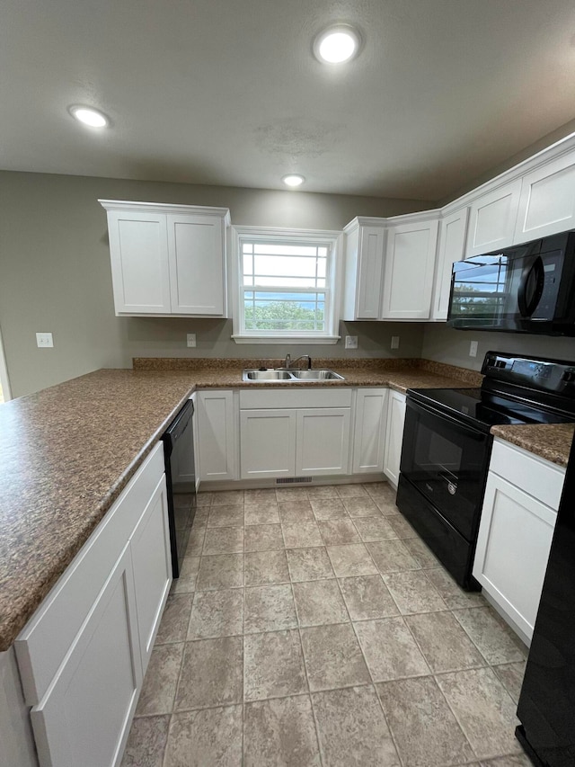 kitchen with white cabinets, sink, and black appliances