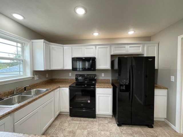 kitchen featuring white cabinets, sink, and black appliances