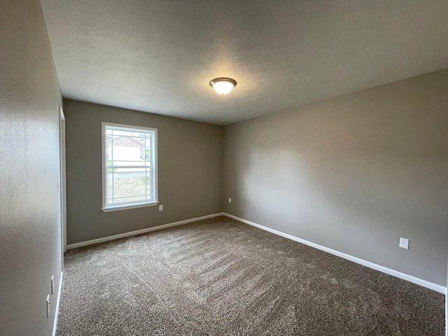 unfurnished room featuring a textured ceiling and carpet flooring