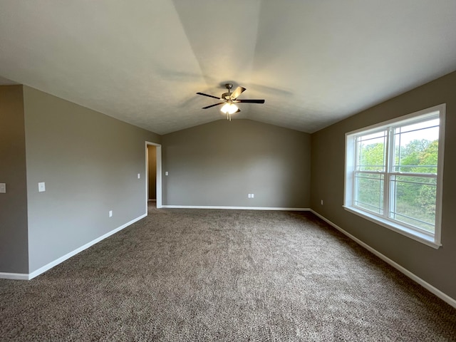 carpeted spare room with ceiling fan and lofted ceiling