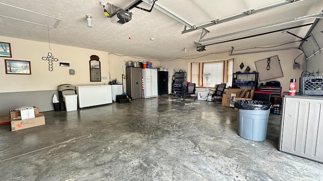 garage with a garage door opener and electric panel