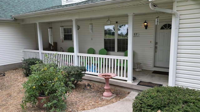 view of exterior entry with a porch