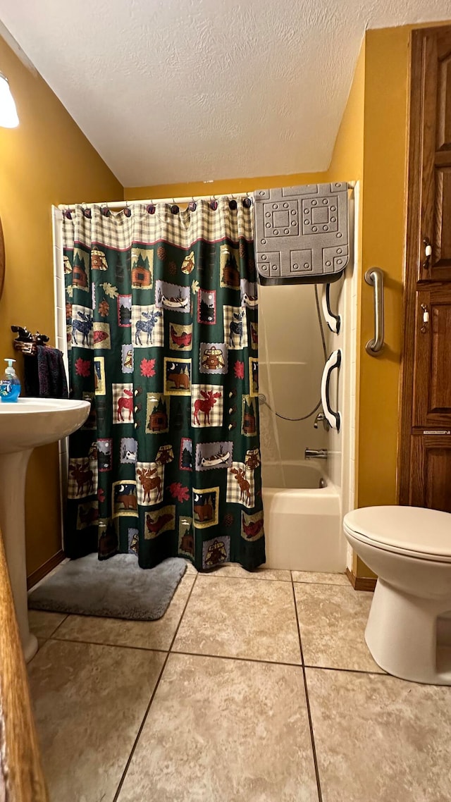 bathroom featuring tile patterned flooring, shower / tub combo, toilet, and a textured ceiling