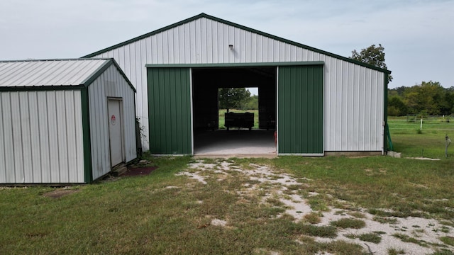 view of outbuilding featuring a lawn