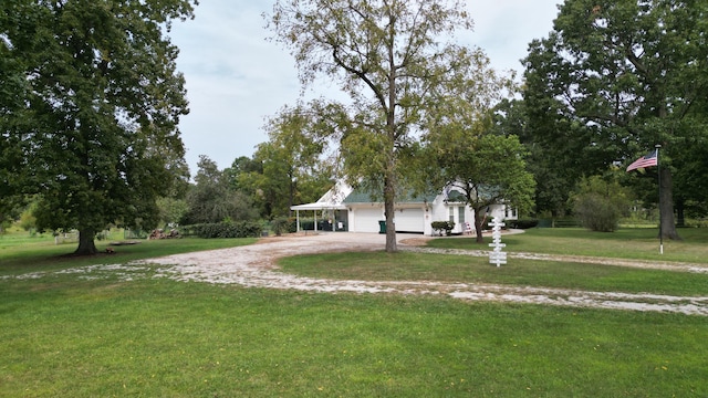 view of front facade with a carport and a front yard