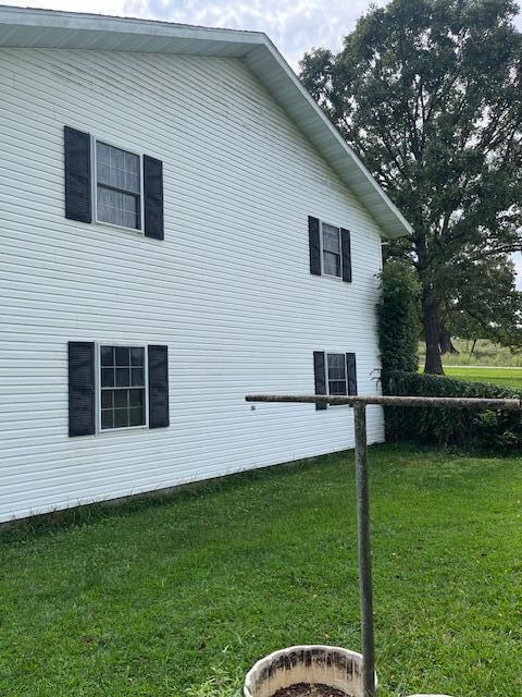 view of side of home featuring a yard