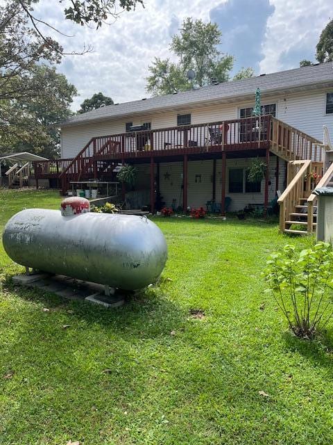 rear view of property with a yard and a deck