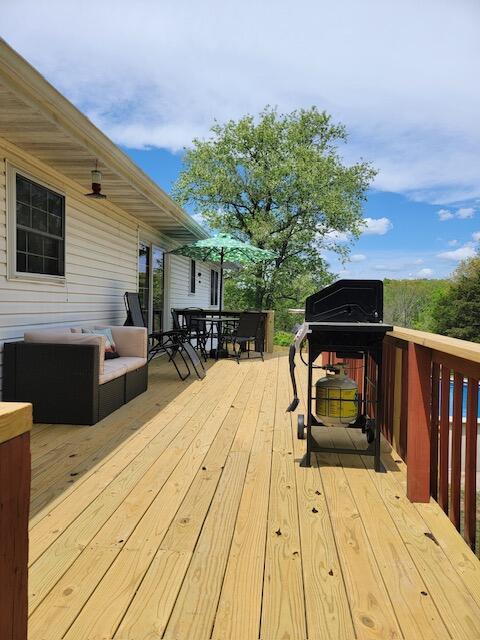 wooden terrace featuring outdoor dining area
