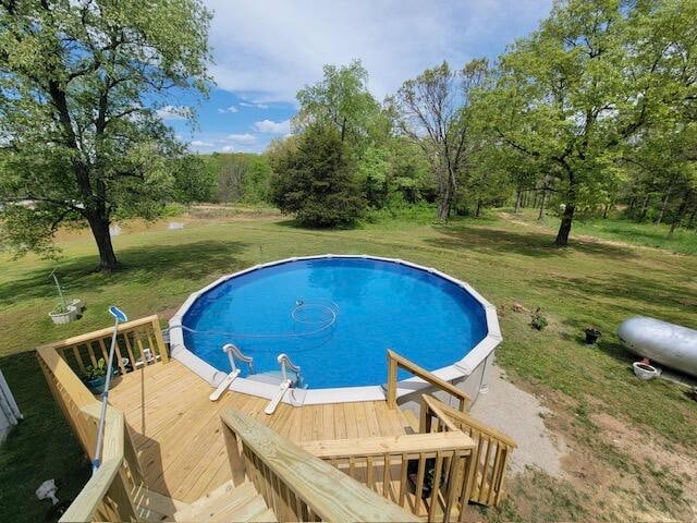 view of pool with a yard and a deck