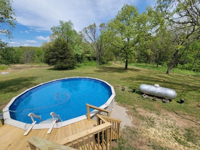 view of pool featuring a lawn