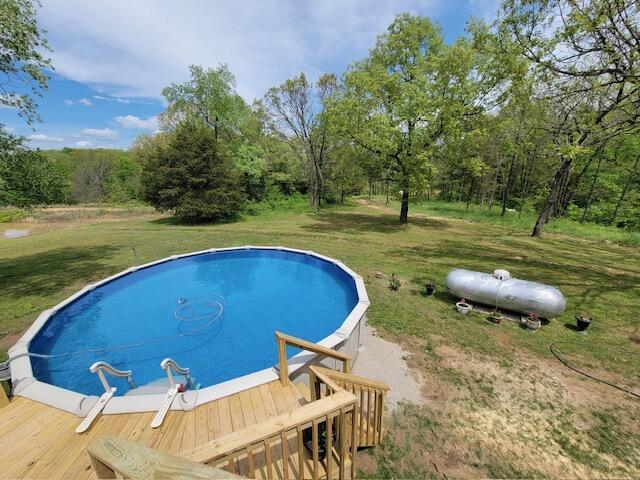 pool with a lawn and a deck