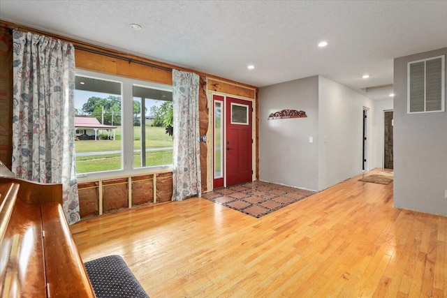 foyer with hardwood / wood-style flooring and a textured ceiling